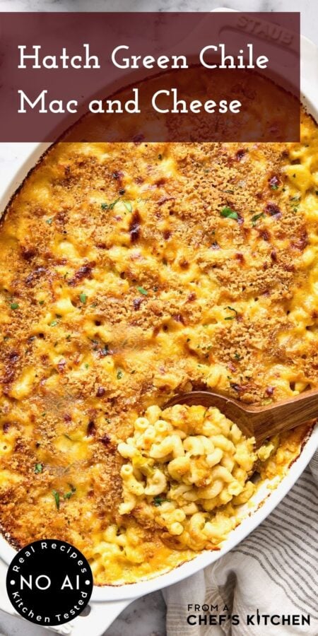 Pinterest graphic for Hatch Green Chile Mac and Cheese showing it in a white baking dish with a wooden spoon scooping some up.