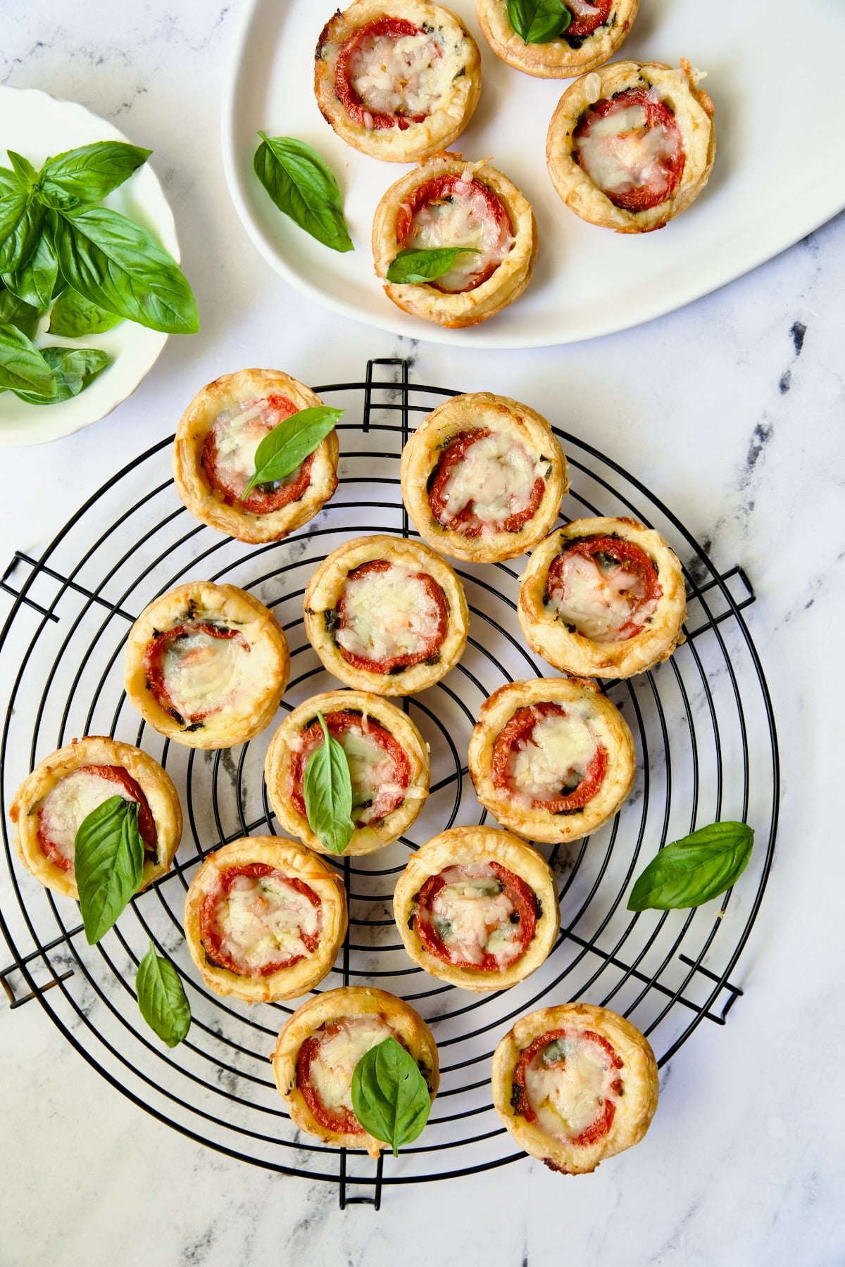 Mini Southern Tomato Pies on round black wire cooling rack.