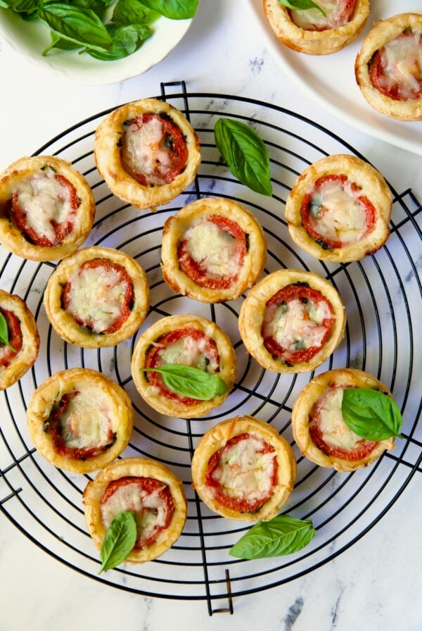 12 Mini Southern Tomato Pies on round black wire cooling rack.