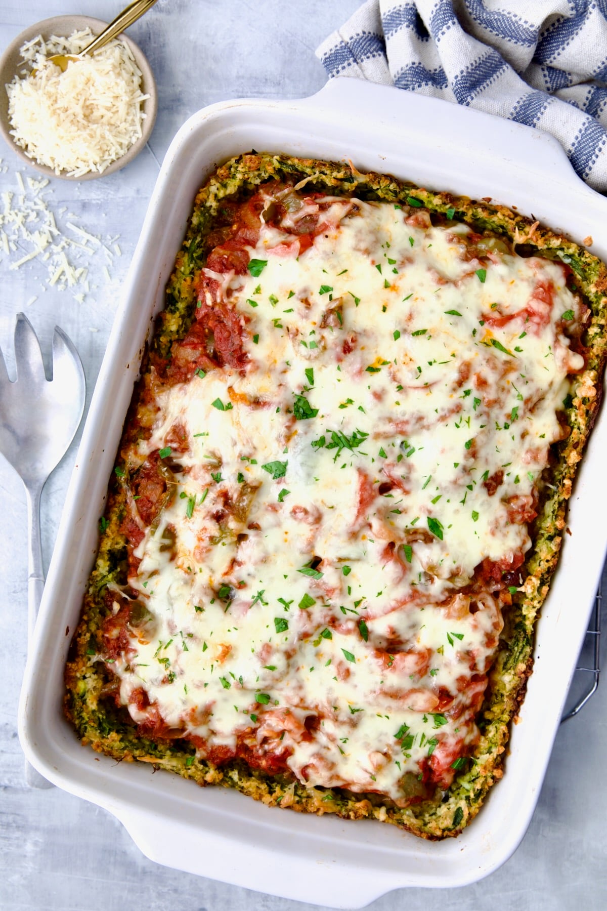 Zucchini Pizza Casserole in white rectangular baking dish before being cut.